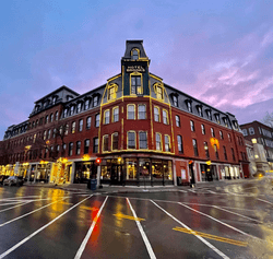 Dusk image of a large red brick building.