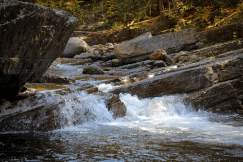 Water cascades over a small rock ledge.