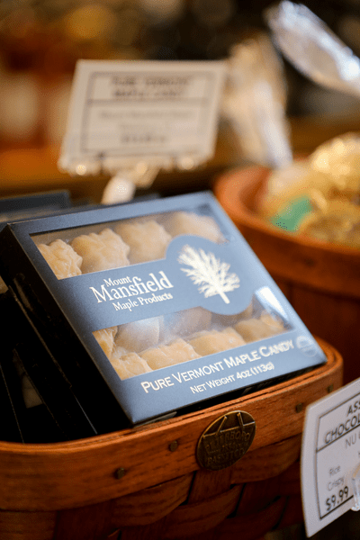 Maple candies in a box are displayed on a counter.