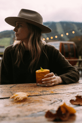 A person drinks a cocktail at a ski resort in the summer.