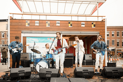 View of a stage with a musical group performing.