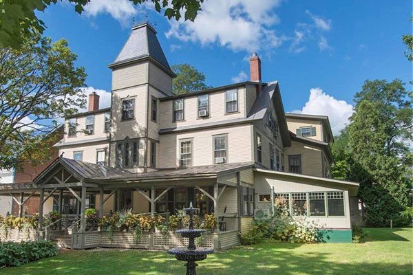 Exterior view of an old Victorian home on a sunny day.