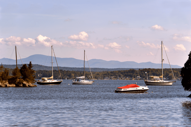 Sailboats on a blue lake on a sunny day.