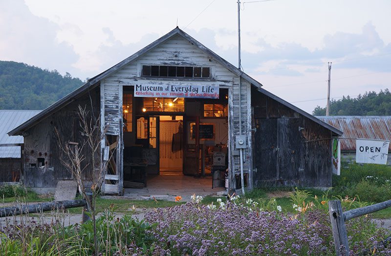 Exterior of a rustic building with artifacts of every day life.