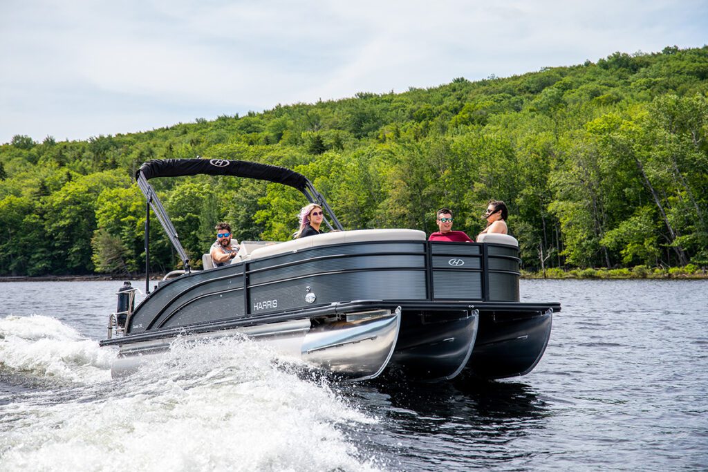 People on a pontoon boat in a lake.