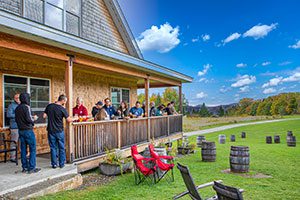 People gather outside at a brewery in the summer.