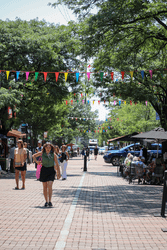 People walk on a pedestrian street on a warm day.