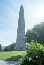 A large stone monument on a warm and sunny day.